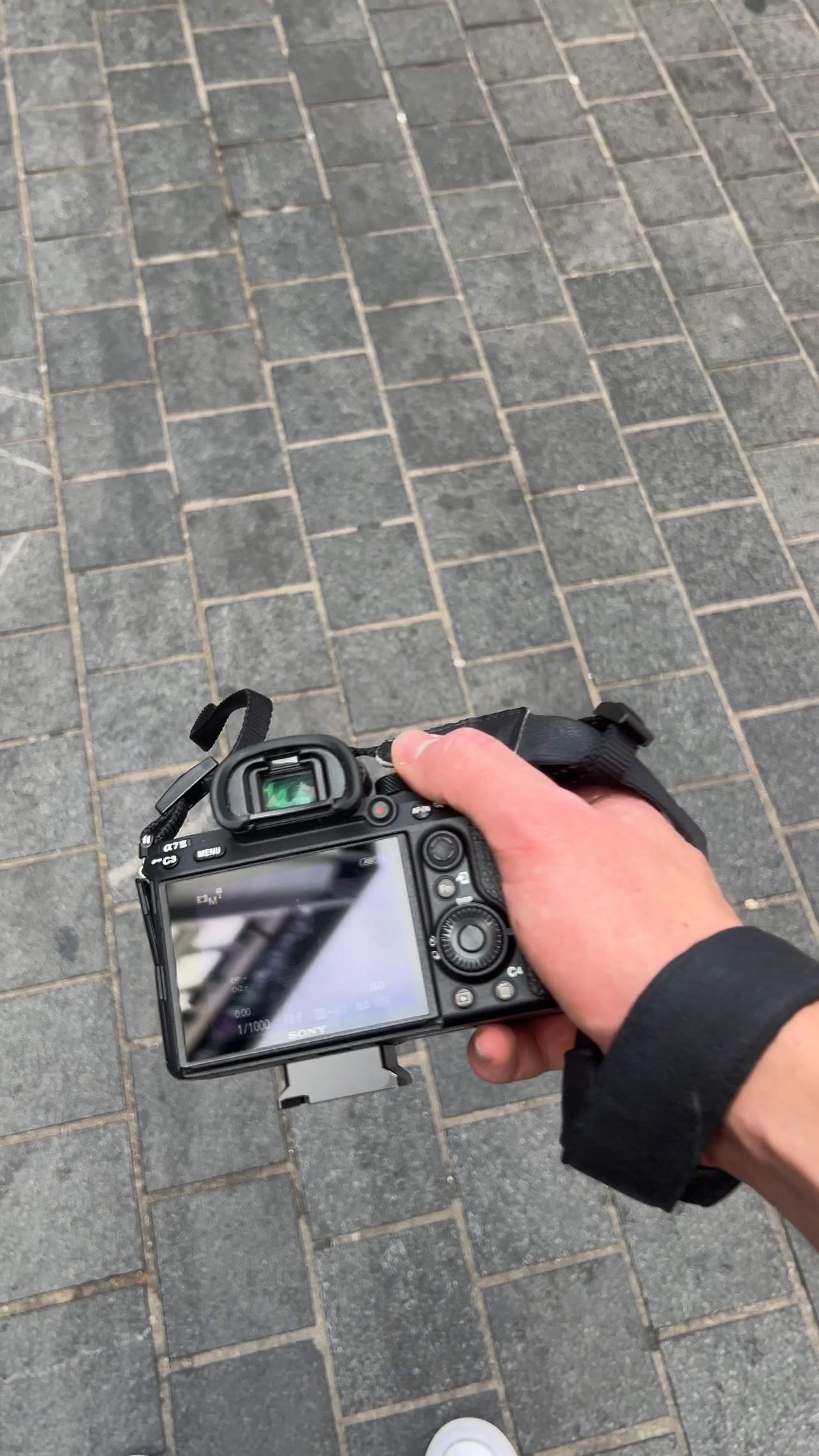 Sony mirrorless camera in hand on location