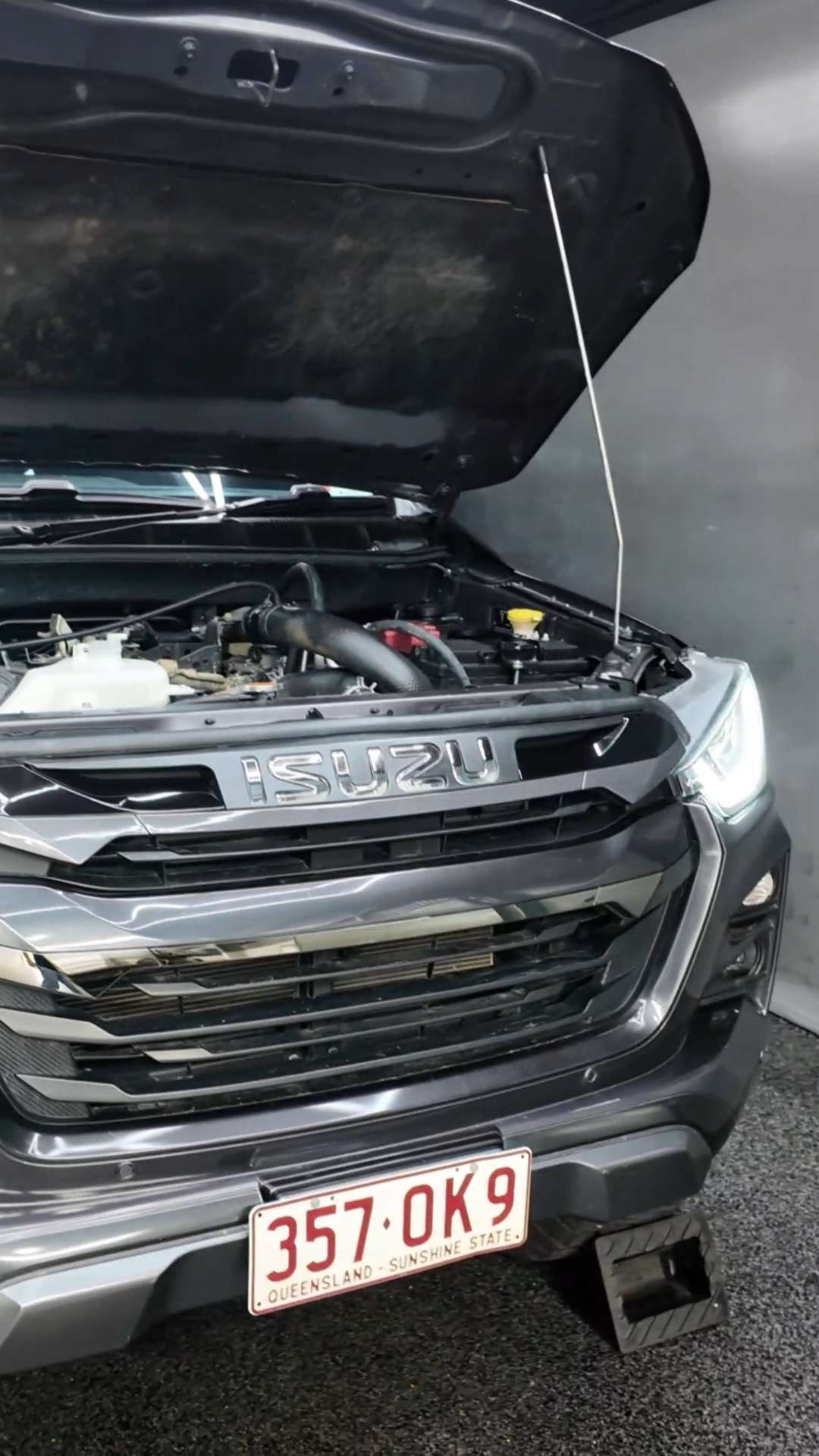 Isuzu D-Max with the bonnet up under hexagon lights
